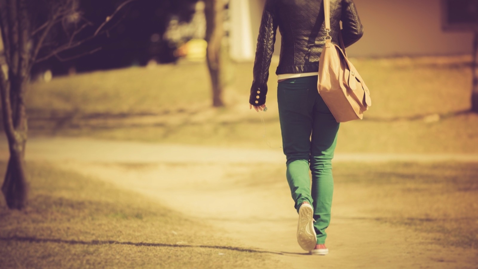 Woman with bag walking at night