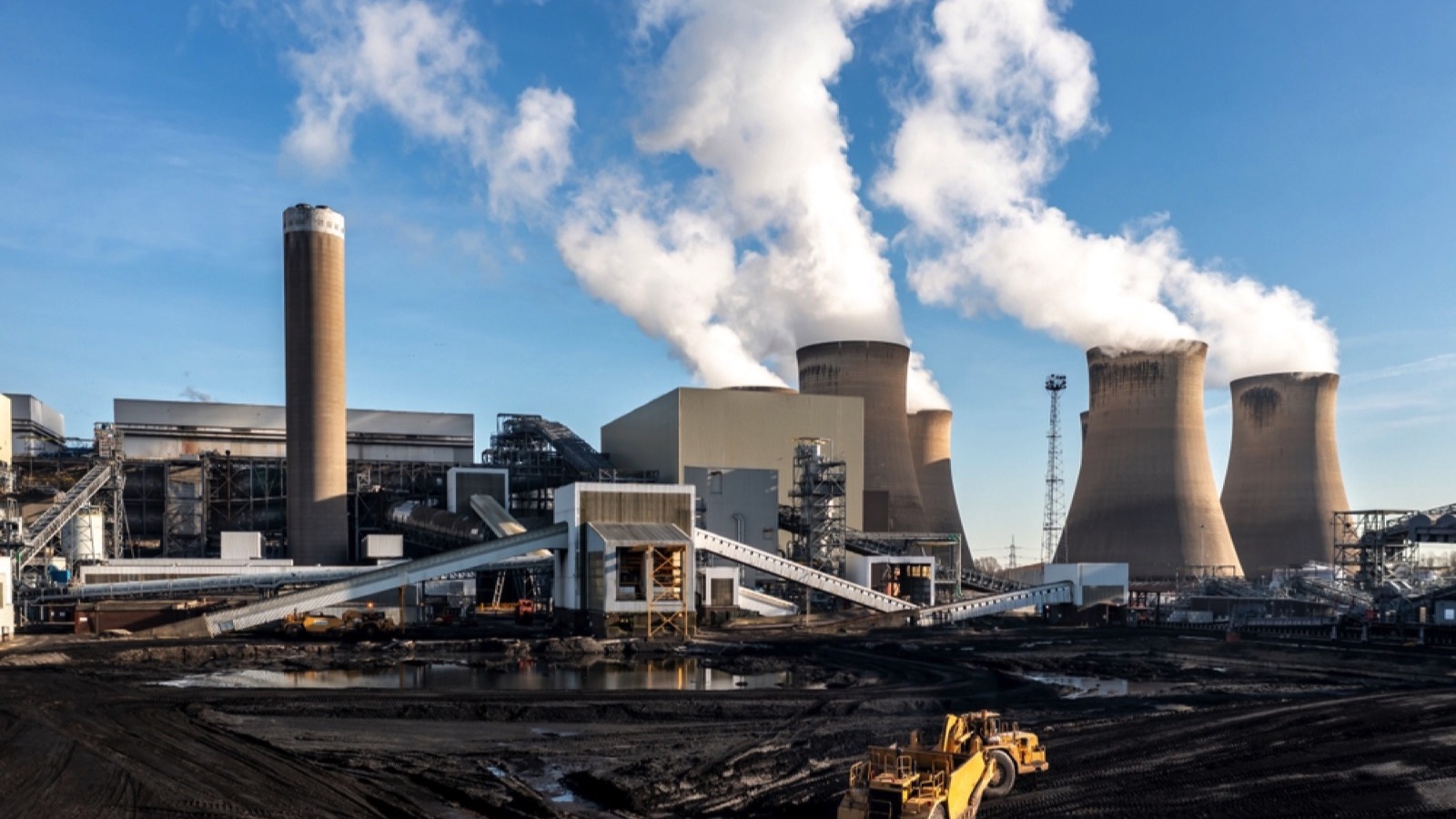 heavy plant machine scraping coal from a fossil fuel stack